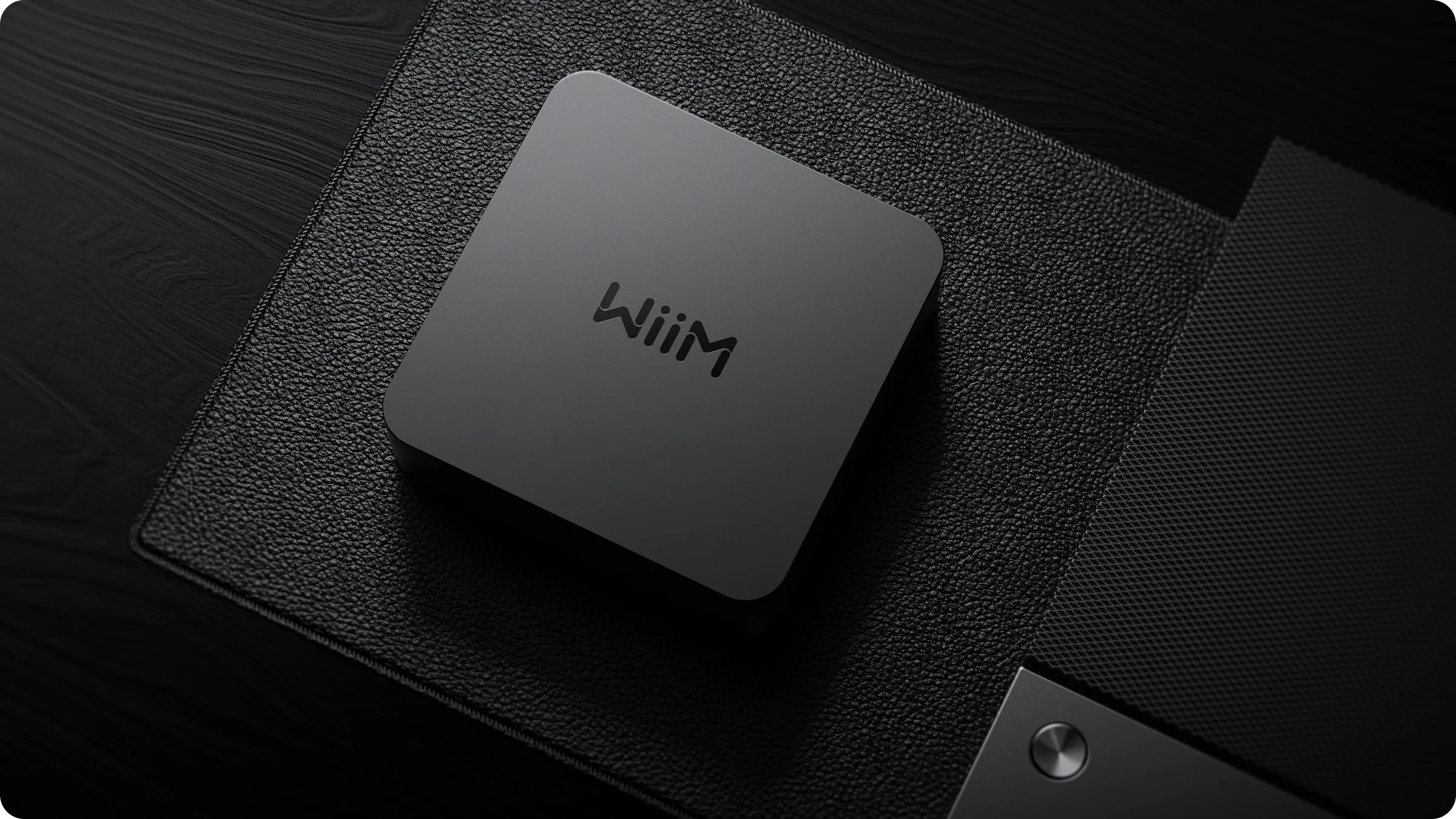 WiiM Pro on a media console next to a classic stereo system